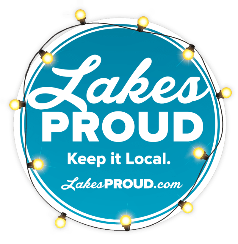 Lakes Proud logo circle shape with blue background and yellow Christmas lights circling image