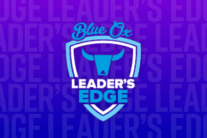 Graphic Image of blue and purple gradient background with the words Leader's Edge repeated in the background and Leader's Edge white and blue logo on top