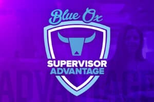Graphic Image of White and Blue Blue Ox Supervisor Advantage logo on top of Purple Background with faded photo of middle aged woman in the back