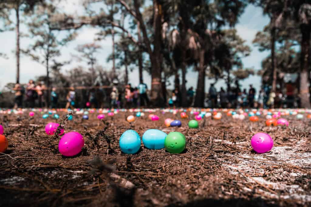 1920x1280 Photo of colorful, plastic easter eggs on the ground at an Easter Eggs hunt
