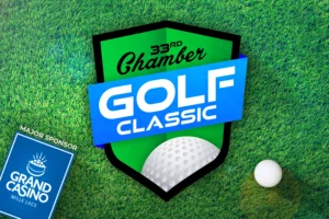 Graphic Image of Green and Blue Chamber Golf Classic logo on top of Grass background