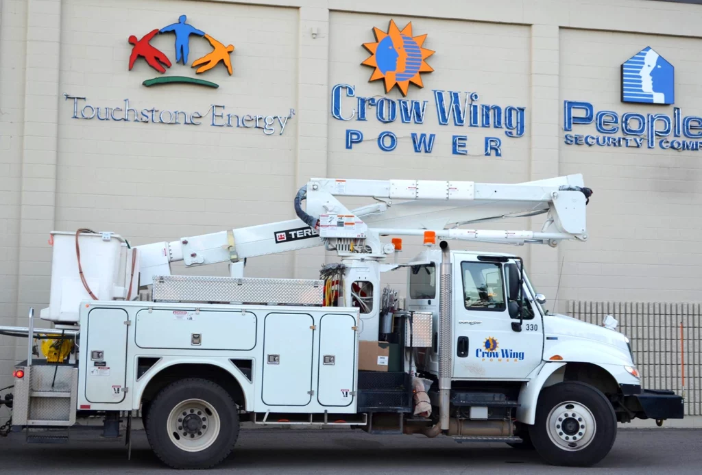 Photo of Crow Wing Power Bucket Truck in parked in front of Crow Wing Power building