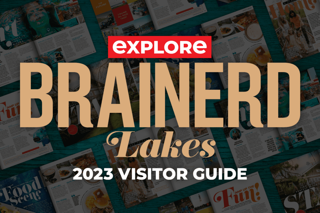 Graphic image of a collage of magazine spreads over a blue wood background with the heading Explore Brainerd Lakes 2023 Visitor Guide on top