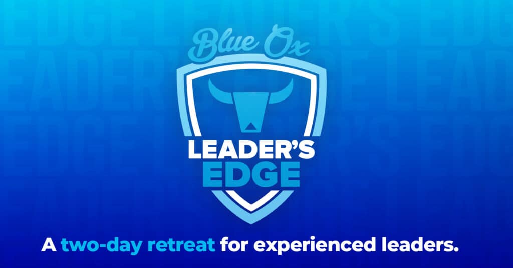 Blue gradient background with the words Leaders Edge repeated in the background with a crest-like logo on top in blue and white that says Leader's Edge